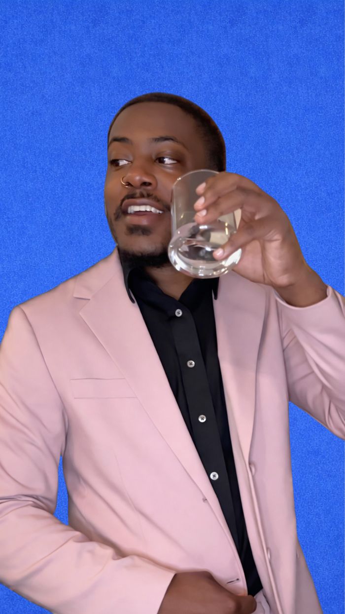 Darrin in a pink blazer against a blue background
