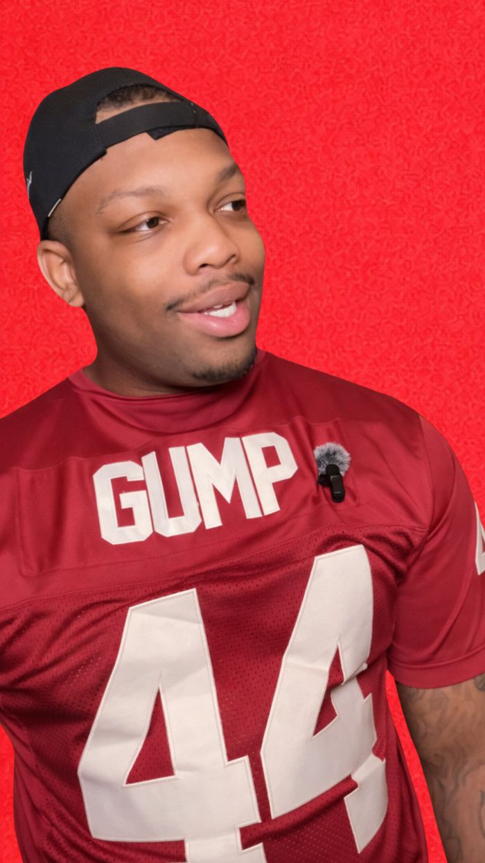 Shaun in a football jersey against a red background